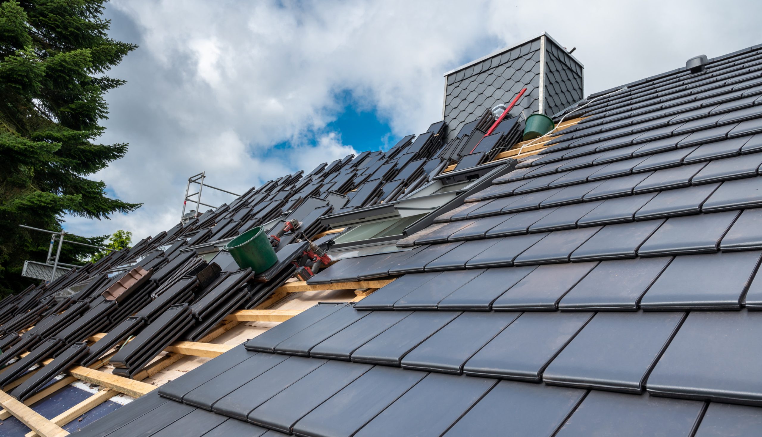 Roofers in West London inspecting a tiled roof